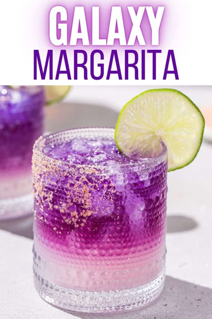 Close up of a Galaxy Margarita with another purple margarita in the background. Text at the top says “Galaxy Margarita” in purple colors.