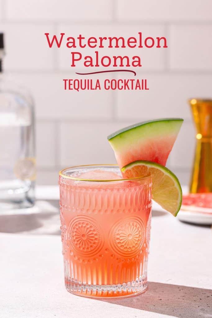 Watermelon Paloma cocktail in a decorated gold-rimmed glass with a watermelon wedge and lime slice as garnish. Text above the drink says “Watermelon Paloma - tequila cocktail”.