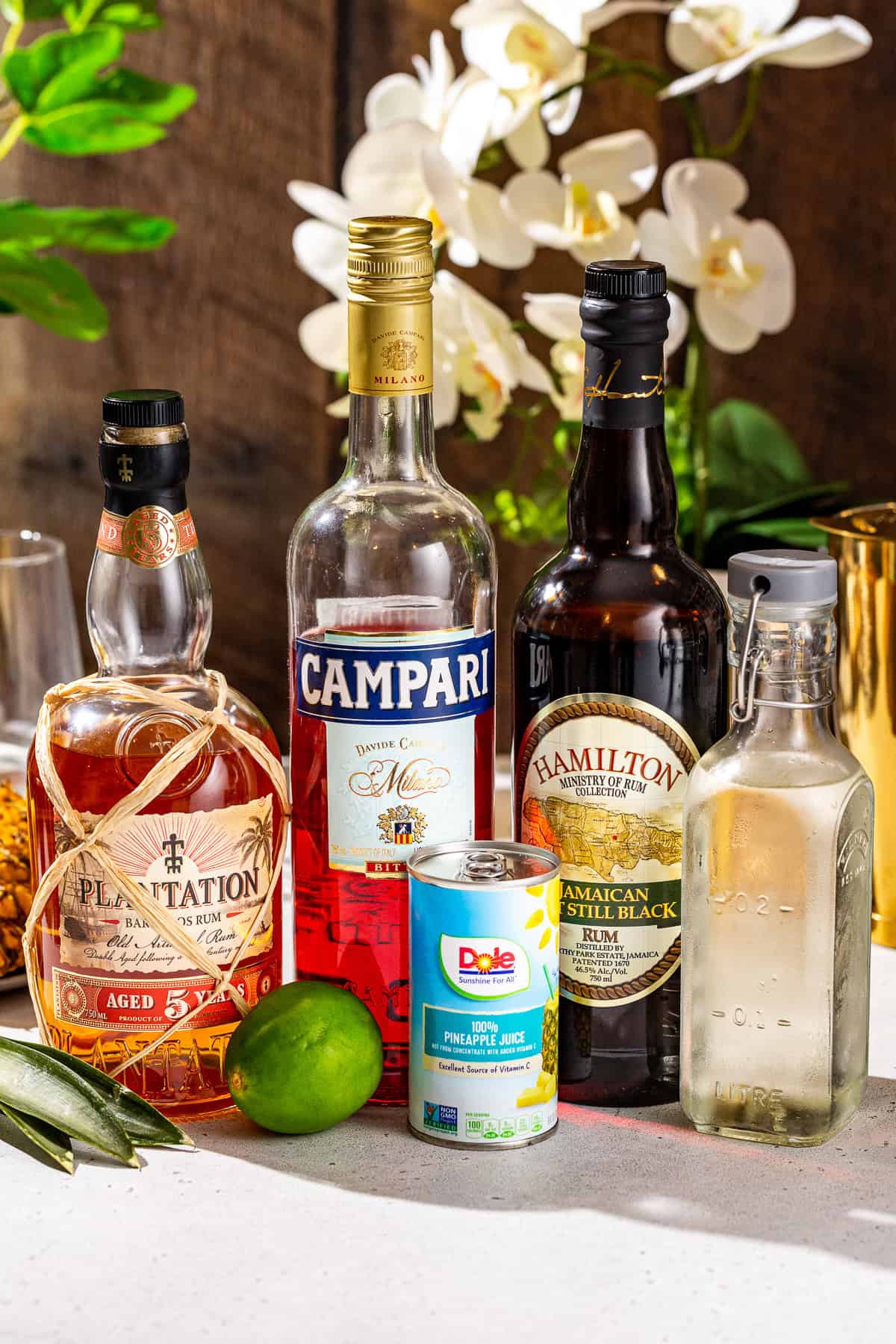 Ingredients to make a Jungle Bird cocktail together on a countertop.