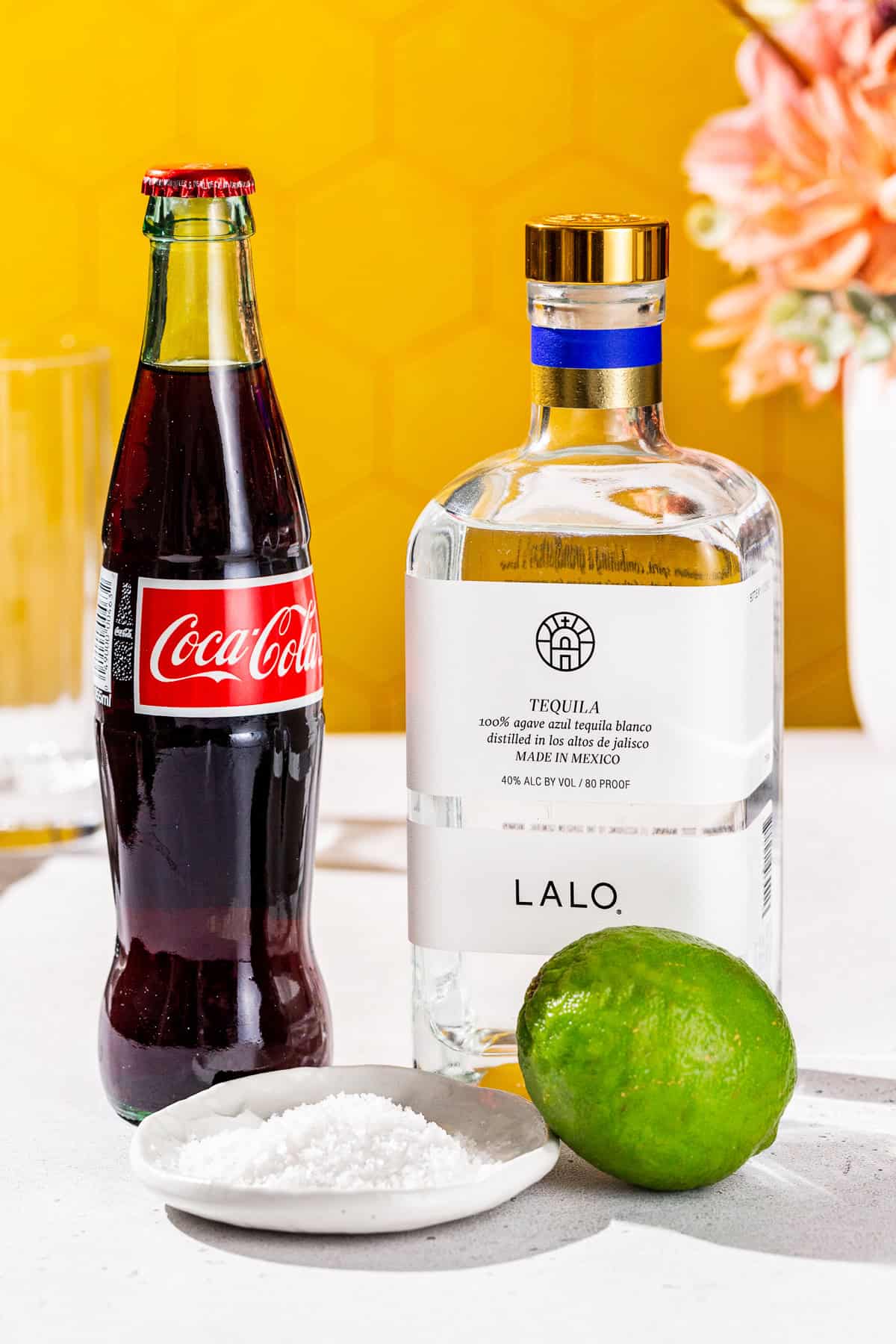 Ingredients to make a Batanga tequila cocktail together on a countertop.