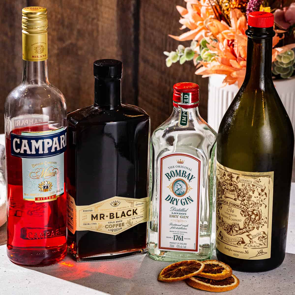 Ingredients to make a Coffee Negroni together on a countertop.