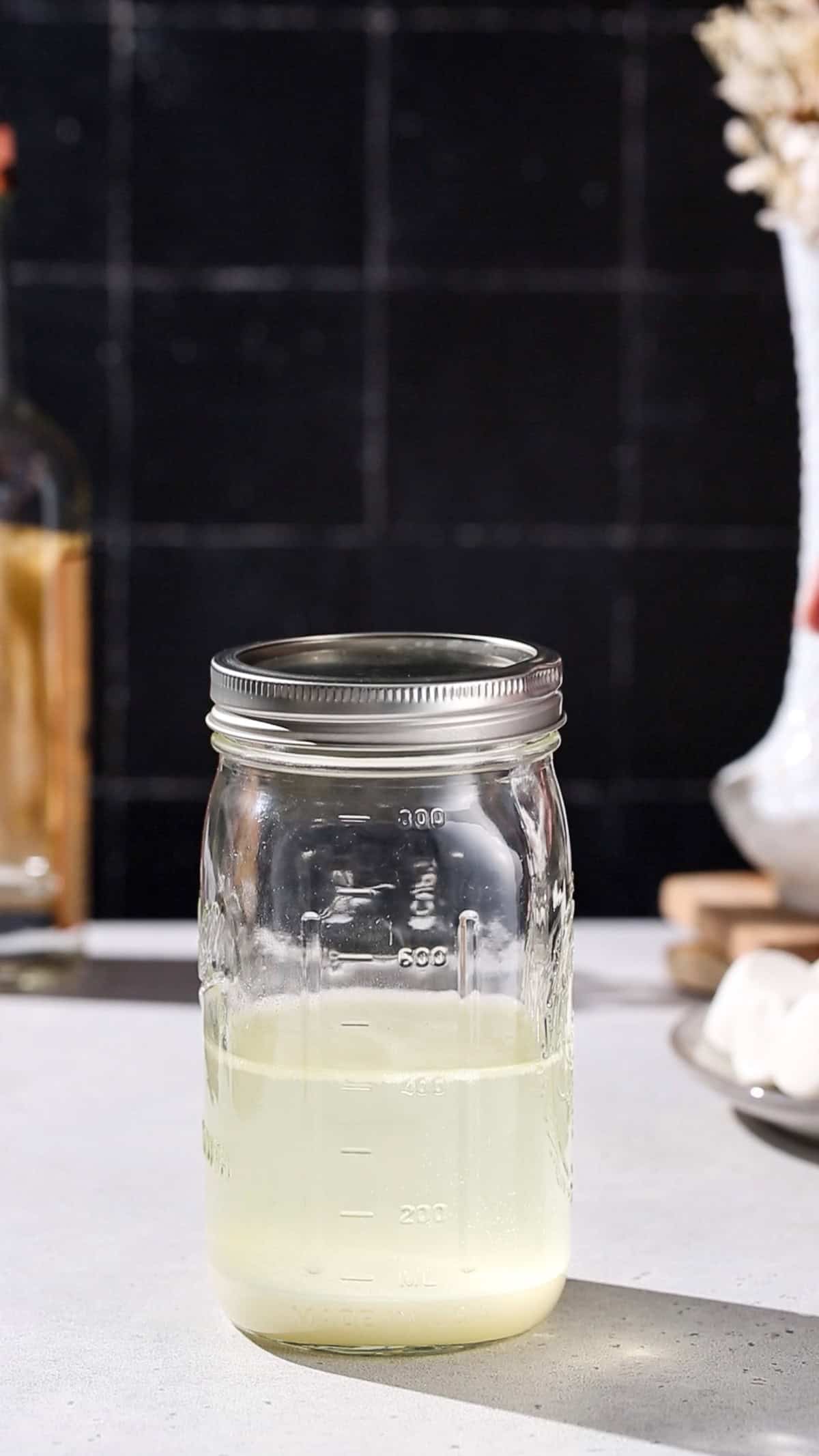 Jar of vodka with infused marshmallows.