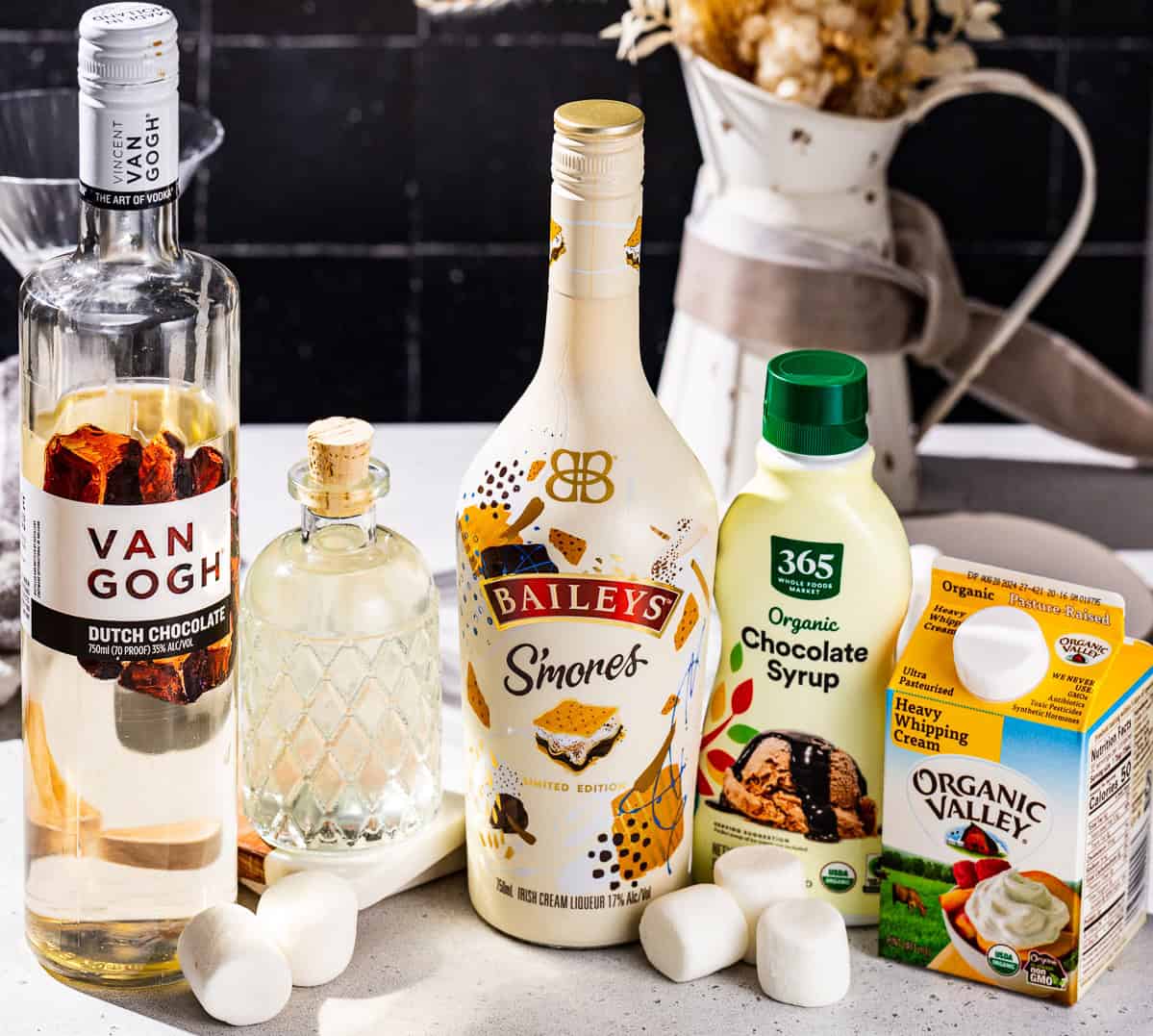 Ingredients to make a Smores martini together on a countertop.