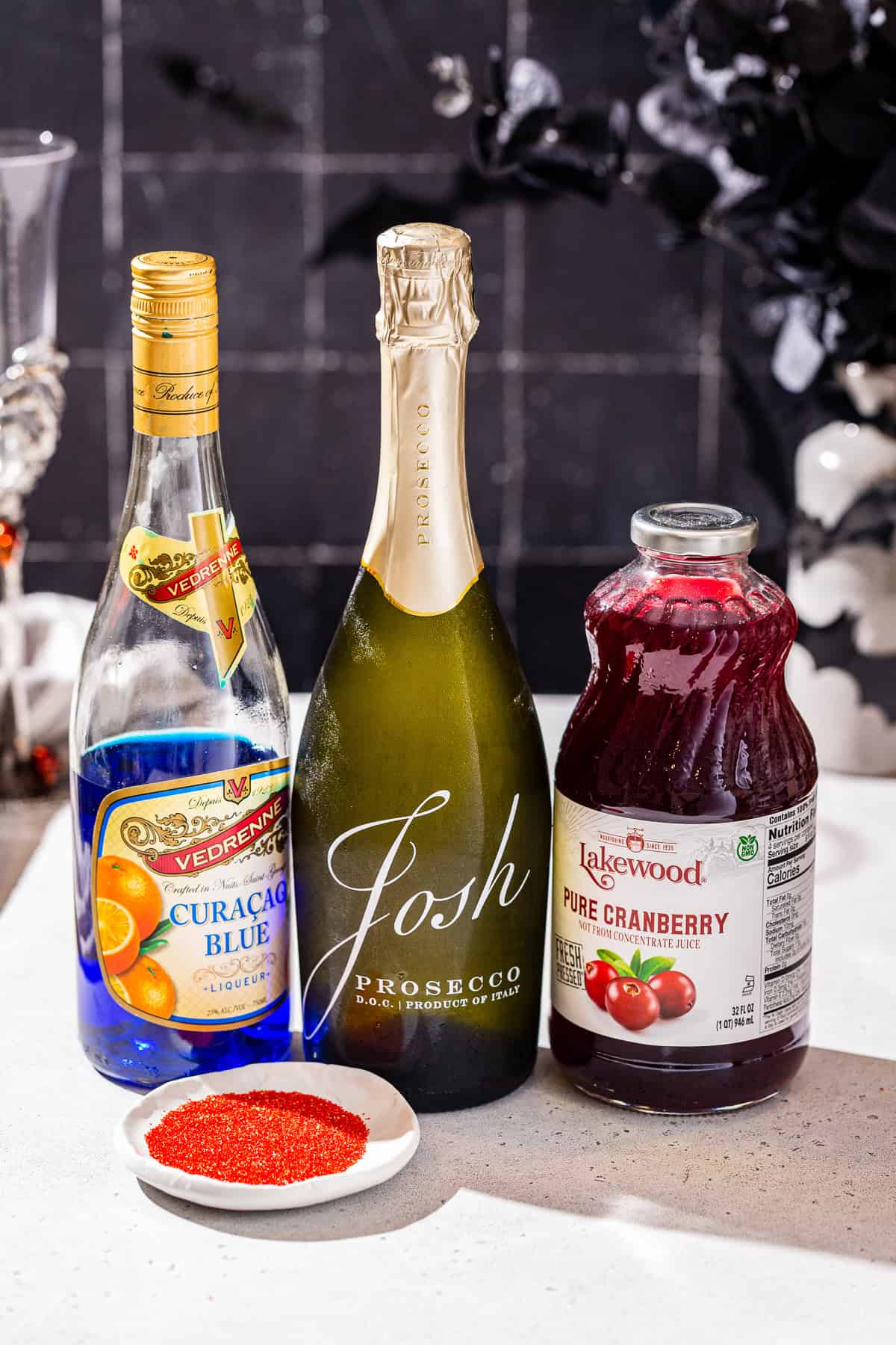 Ingredients to make a Black Mimosa together on a countertop.