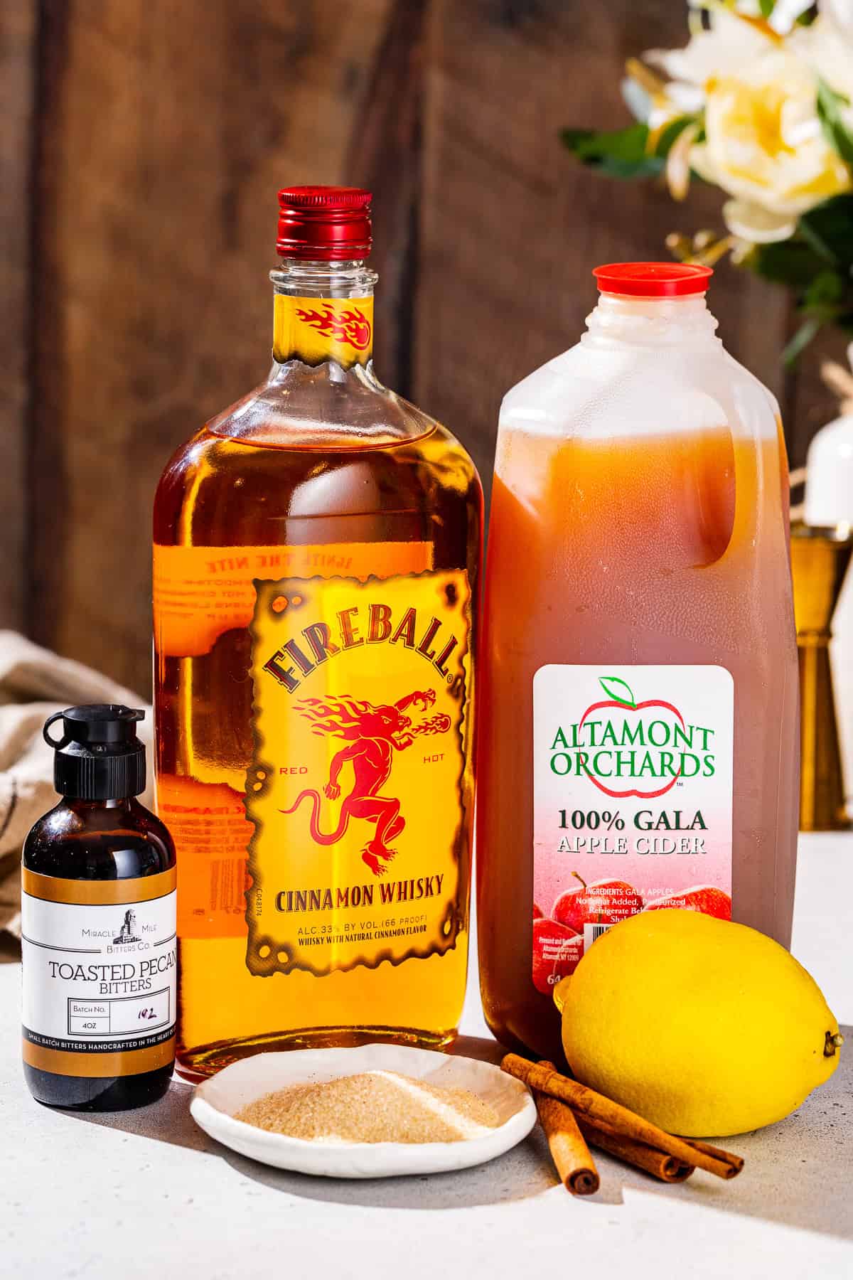 Ingredients to make a Fireball Apple Cider together on a countertop.