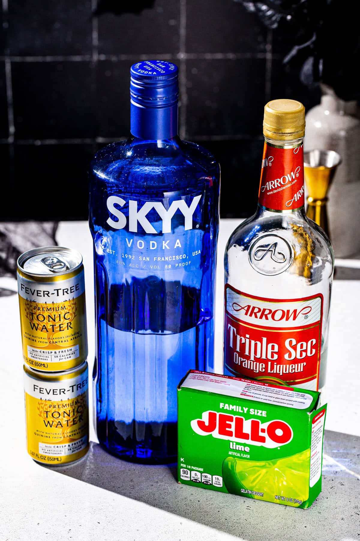 Ingredients to make Glow in the dark Jello Shots together on a countertop.