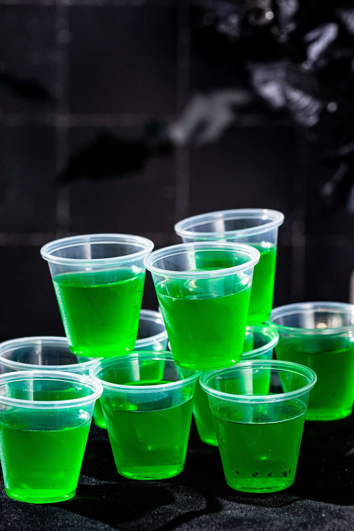 Lime glow in the dark jello shots shown in natural light.