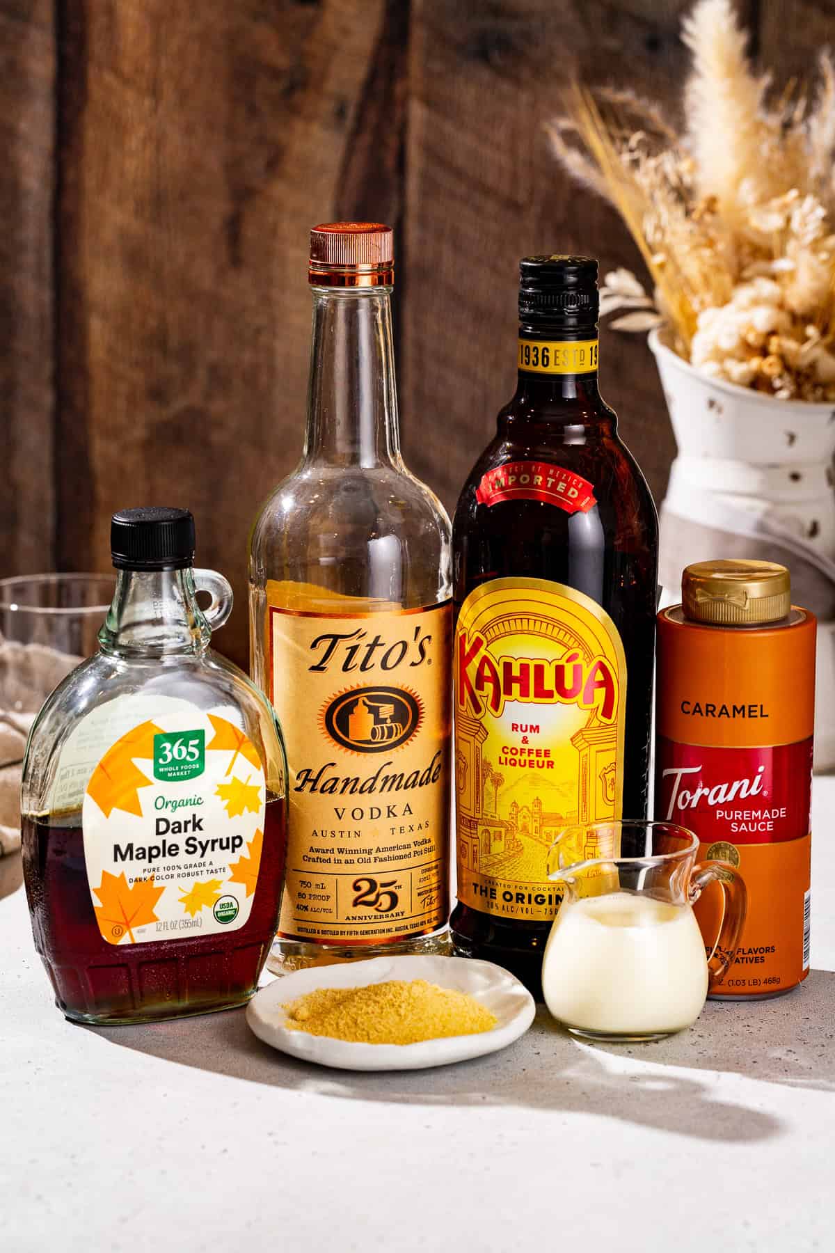 Ingredients to make a Maple Caramel White Russian together on a countertop.