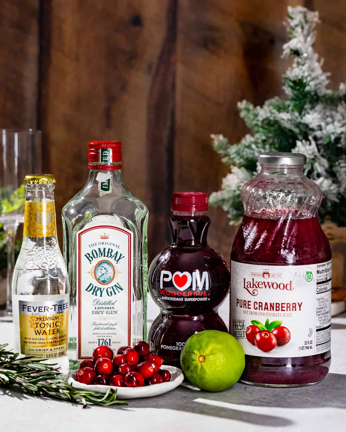 Ingredients to make a Holiday Gin and Tonic together on a countertop.