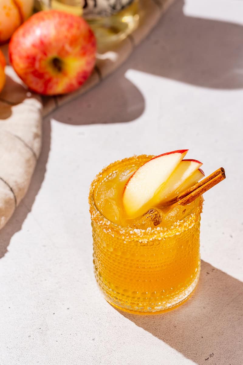 Thanksgiving Margarita on a countertop with an apple in the background.