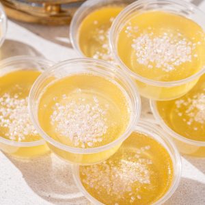 Overhead view of some Champagne jello shots with glitter sugar garnish.