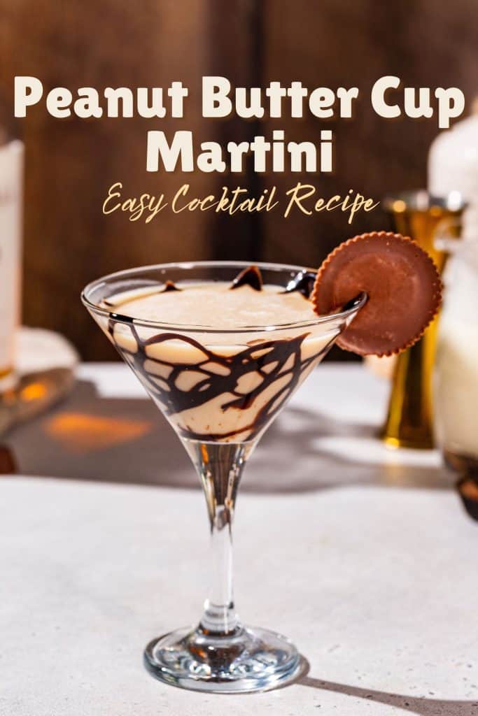 Peanut Butter Cup Martini on a countertop, garnished with a chocolate syrup drizzle and a whole peanut butter cup. Text above the drink says “Peanut Butter Cup Martini - easy cocktail recipe”.