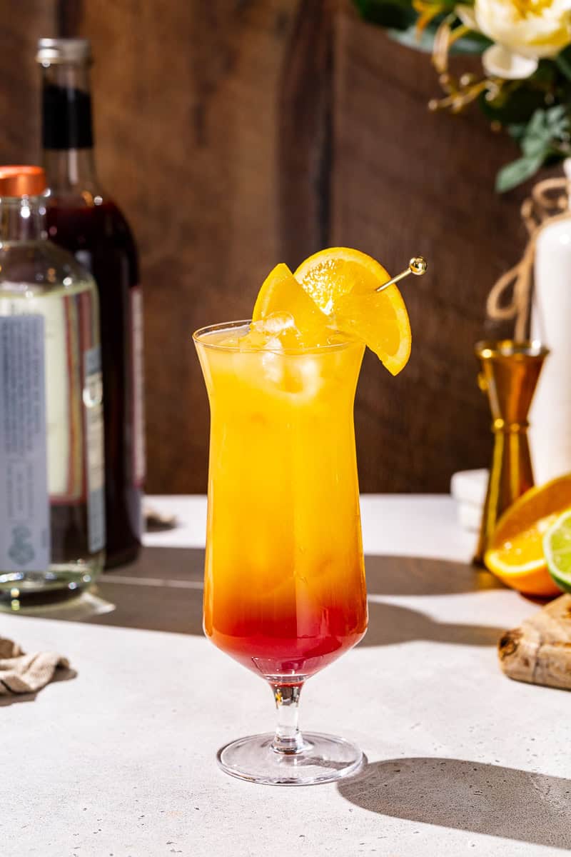 Side view of a Tequila Sunrise Mocktail on a countertop.